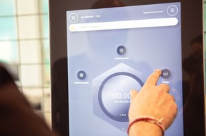 A user operates a multi-front-end HMI on a touchscreen display.